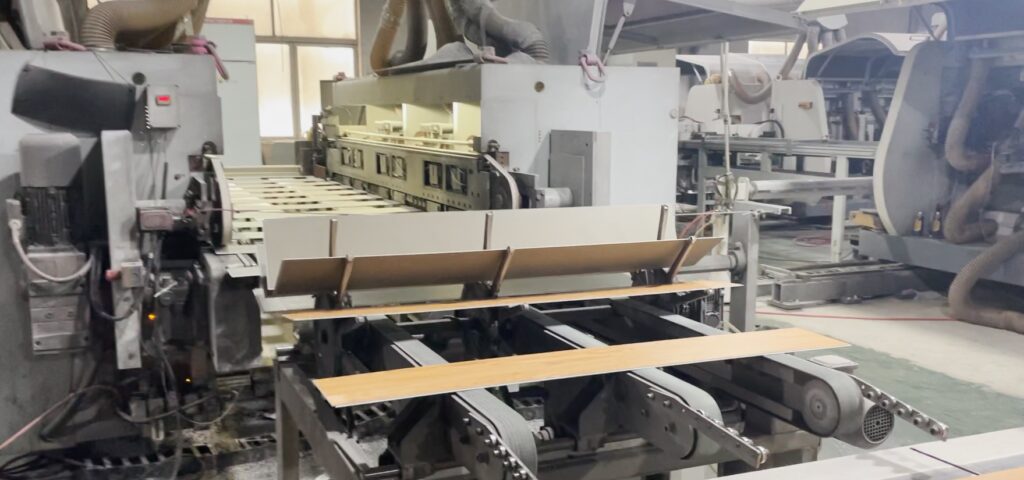 SPC flooring manufacturing line overview showing extrusion and profiling process